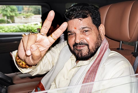 Former BJP MP and ex-WFI chief Brij Bhushan Sharan Singh shows victory sign after Delhi court acquits him in a sexual harassment case filed by women wrestlers. 