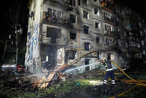 Emergency services personnel work to extinguish a fire following Russian missile attacks in Kyiv, Ukraine, Saturday, Aug. 1, 2026. 
