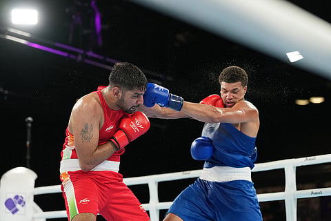 India's Narender Berwal, left, competes with England's Damar Thomas in the men's 90kg boxing final at the Commonwealth Games in Glasgow, Scotland.