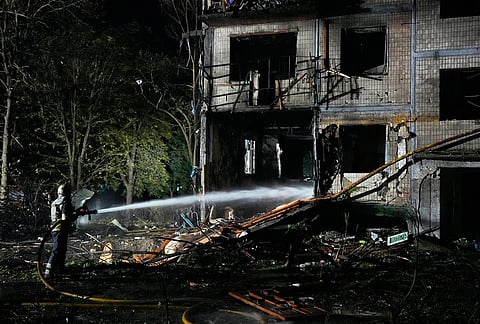 Emergency services personnel work to extinguish a fire following Russian missile attacks in Kyiv, Ukraine, Saturday, Aug. 1, 2026. 