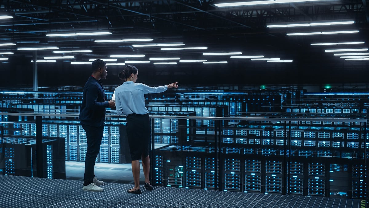 Two engineers overlooking a large data center