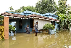 Residents wade through floodwaters outside their inundated homes after incessant monsoon rains caused widespread flooding, at Ranni, in Pathanamthitta district of Kerala, Monday, Aug. 3, 2026. - | Photo: PTI