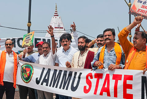 Members of the Jammu State Movement stage a protest demanding separate statehood for the Jammu region near the Maharaja Hari Singh statue at Tawi Bridge, in Jammu.