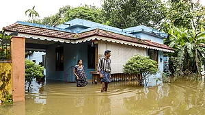 | Photo: PTI : Residents wade through floodwaters outside their inundated homes after incessant monsoon rains caused widespread flooding, at Ranni, in Pathanamthitta district of Kerala, Monday, Aug. 3, 2026.
