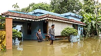 | Photo: PTI : Residents wade through floodwaters outside their inundated homes after incessant monsoon rains caused widespread flooding, at Ranni, in Pathanamthitta district of Kerala, Monday, Aug. 3, 2026. 