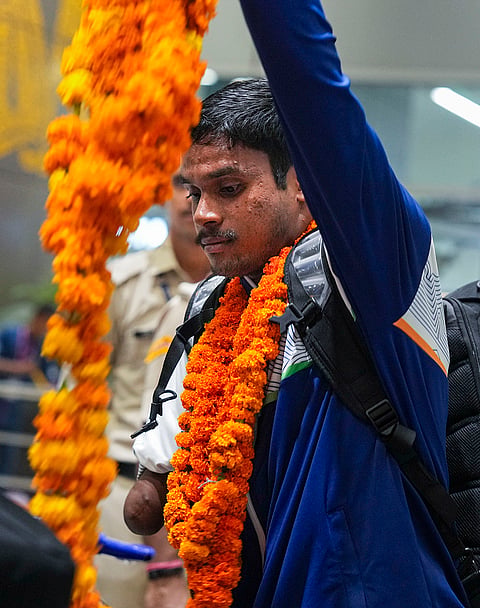 Para-athlete gold medallist Dilip Mahadu Gavit being welcomed on his arrival after the Glasgow Commonwealth Games, at IGI Airport in New Delhi, early Tuesday, Aug. 4, 2026.