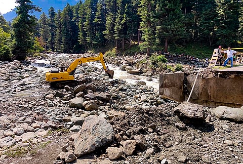 Restoration work is underway after a bridge collapsed following a cloudburst, at Langanbal in Pahalgam, Anantnag.