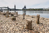 | Photo:  AP/Martin Meissner : Remains of the post-World War II Patton Bridge are exposed during historically low water levels of the Rhine River during a heat wave and a prolonged drought, across from the Cologne Cathedral in Cologne, Germany, Monday, Aug. 3, 2026.
