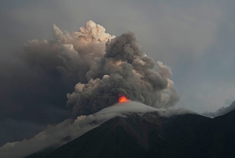 Lava flows and clouds of ash from the crater of the Fuego Volcano, as seen from San Juan Alotenango, Guatemala, Tuesday, Aug. 4, 2026. 