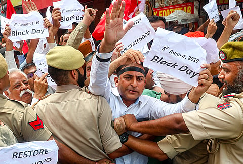 Police stop Jammu and Kashmir National Conference (JKNC) workers during a protest on the seventh anniversary of the abrogation of Article 370, demanding the restoration of the special status of the erstwhile state of J-K, in Jammu, Wednesday, Aug. 5, 2026. 