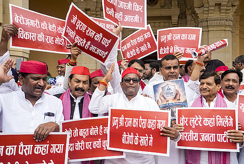 Samajwadi Party MLAs stage a protest over the alleged theft of Ram temple donations, during the Monsoon session of the Uttar Pradesh Legislative Assembly, in Lucknow.