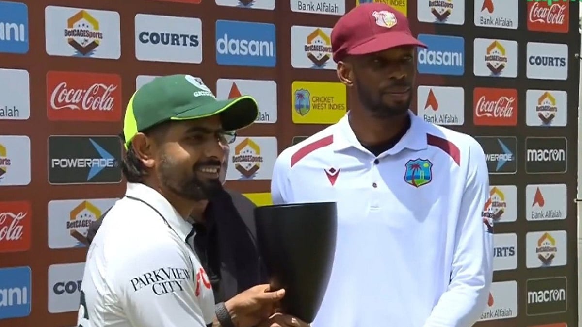 Pakistan captain Babar Azam posing  alongside West Indies skipper Roston Chase as they share the tropy - X