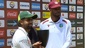 X : Pakistan captain Babar Azam posing alongside West Indies skipper Roston Chase as they share the tropy