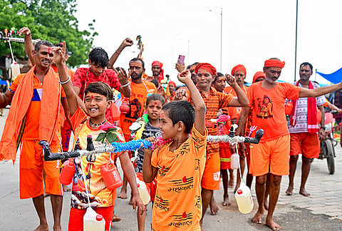 'Kawariyas' carry holy Ganga water during the first day of the holy month of Sawan, in Prayagraj, Uttar Pradesh, Thursday, July 30, 2026.