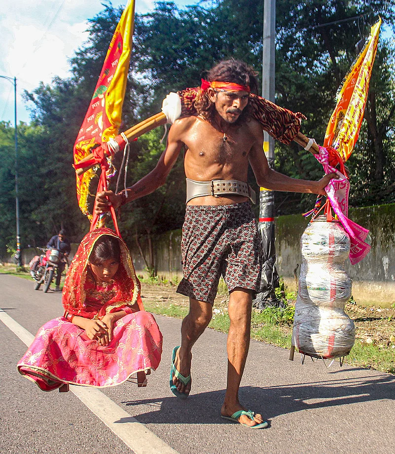 Carrying decorated Kanwar poles