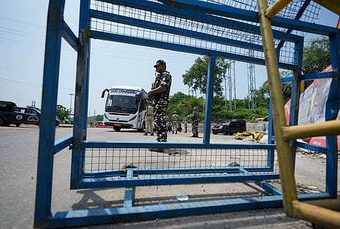 Security personnel check a passanger's vehicle as the security grid in Jammu and Kashmir is placed on high alert ahead of the seventh anniversary of the abrogation of Article 370 of the Constitution, in Jammu Tuesday, Aug 4, 2026.