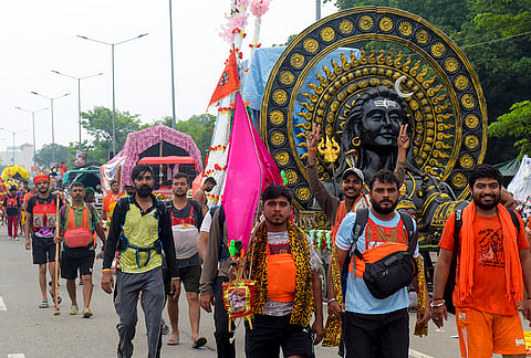 'Kanwariyas’ carry water from the Ganga river as part of ‘Kanwar Yatra’ during the month of ‘Shravan’, in Haridwar, Wednesday, Aug. 5, 2026. 