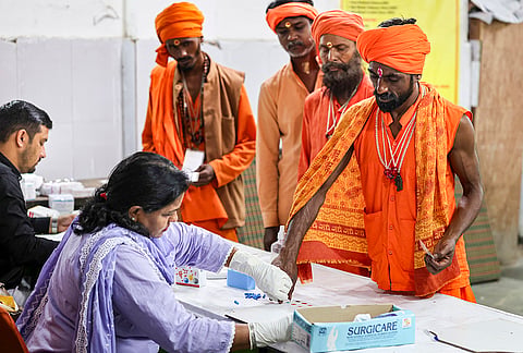 Seers undergo blood test during the registration for the annual 'Amarnath Yatra' at Ram temple base camp, in Jammu, Jammu and Kashmir.  The pilgrimage was suspended from the base camp as authorities heighten security across J-K on the seventh anniversary of the abrogation of Article 370. 