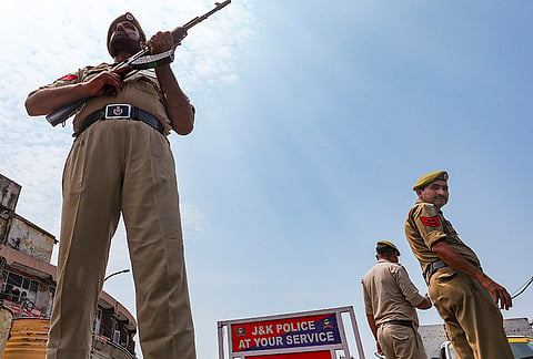 Police personnel stand guard as part of heightened security arrangements ahead of the seventh anniversary of the abrogation of Article 370 and Article 35A, in Jammu, Tuesday, Aug. 4, 2026. 