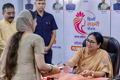 In this image posted on Aug. 6, 2026, Delhi Chief Minister Rekha Gupta interacts with a beneficiary at a Delhi Lakshmi Yojana registration camp in Shalimar Bagh, New Delhi.