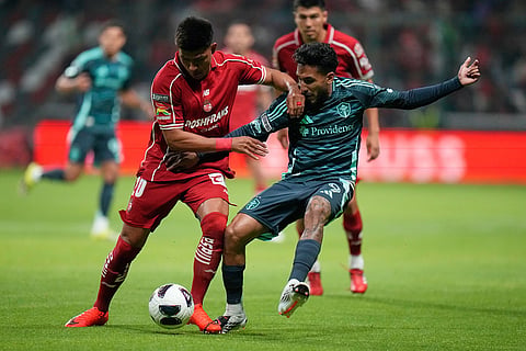 Jesús Gallardo of Mexico's Toluca, left, and Jesús Ferreira of The United States Seattle Sounders FC vie for the ball during a Leagues Cup soccer match in Toluca, Mexico.