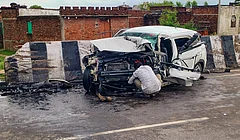 Jhansi: A man sits near a wreckage of a car after it crashed into a divider, in Jhansi, Uttar Pradesh, Thursday, Aug. 6, 2026. Aban Ahmad, the youngest son of slain gangster-turned-politician Atiq Ahmad, and his friend were killed. - PTI Photo