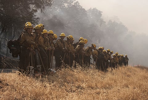 Cal Fire hand crew members from the Madera-Mariposa-Merced Unit's Castle Fire Center watch for spot fires while battling the Gann Fire near Angels Camp in Calaveras County, California, Tuesday, Aug. 4, 2026. 