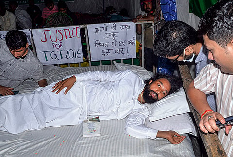 Student leader Devendra Nath Mahto being checked by medical professionals during his hunger strike as part of a protest against the Jharkhand government over alleged irregularities in the 14th JPSC examination, JSSC-CGL and other recruitment tests, demanding a CBI probe and reforms in the recruitment agencies, at Jaipal Singh Munda Stadium, in Ranchi, Monday, Aug. 3, 2026. 