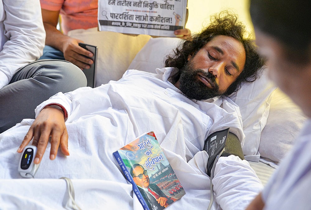 Student leader Devendra Nath Mahto being checked by medical professionals during his hunger strike as part of a protest against the Jharkhand government over alleged irregularities in the 14th JPSC examination, JSSC-CGL and other recruitment tests, demanding a CBI probe and reforms in the recruitment agencies, at Jaipal Singh Munda Stadium, in Ranchi, Monday, Aug. 3, 2026.