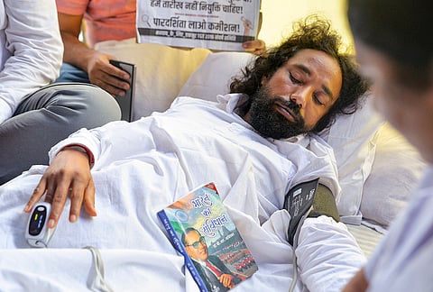 Student leader Devendra Nath Mahto being checked by medical professionals during his hunger strike as part of a protest against the Jharkhand government over alleged irregularities in the 14th JPSC examination, JSSC-CGL and other recruitment tests, demanding a CBI probe and reforms in the recruitment agencies, at Jaipal Singh Munda Stadium, in Ranchi, Monday, Aug. 3, 2026.