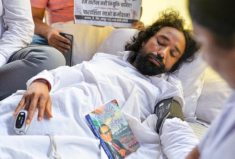 Student leader Devendra Nath Mahto being checked by medical professionals during his hunger strike as part of a protest against the Jharkhand government over alleged irregularities in the 14th JPSC examination, JSSC-CGL and other recruitment tests, demanding a CBI probe and reforms in the recruitment agencies, at Jaipal Singh Munda Stadium, in Ranchi, Monday, Aug. 3, 2026.