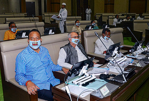 BJP MLA Navin Jaiswal, left, BJP MP Manoj Kumar Yadav, centre and others wear a face mask printed with a demand to cancel the 14th JSSC examination regarding the JPSC and JSSC paper leak issues during the first day of the monsoon session of the Jharkhand Legislative Assembly, in Ranchi.
