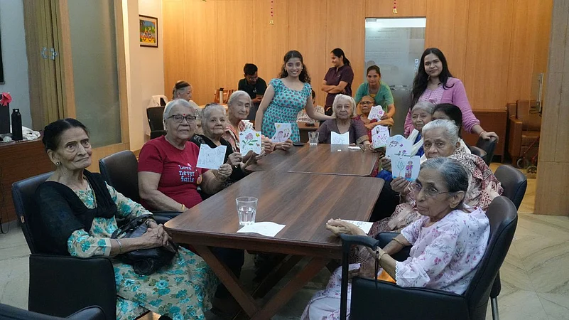 Seniors at a table showing greeting cards