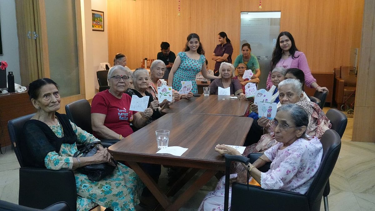 Seniors at a table showing greeting cards