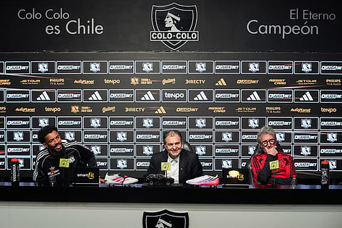 Cape Verde goalkeeper Vozinha, left, Colo Colo's President Anibal Mosa, center, and Colo Colo's sports manager Daniel Moron attend Vozinha's presentation as a new player at Monumental stadium in Santiago, Chile.