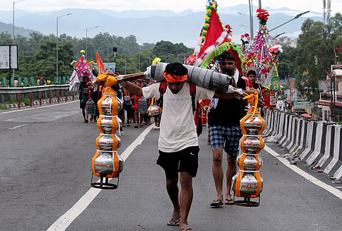 'Kanwariyas' carry holy water from the Ganga river for the annual Kanwar Yatra during the holy month of 'Shravan', in Haridwar, Uttarakhand.