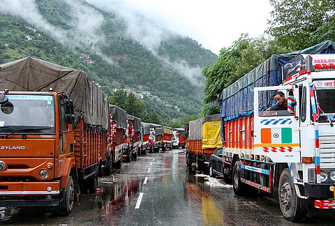Trucks remain parked as the water level of the Beas river rises following continuous rainfall, in Kullu, Himachal Pradesh.
