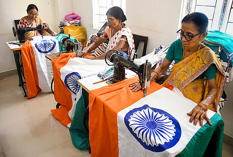 Assam Khadi and Village Industries Board employees prepare the Indian national flag ahead of the Independence Day, in Guwahati, Assam.