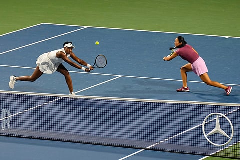 Philippines' Alexandra Eala, right, and United States' Venus Williams try for a return during their doubles match against Japan's Miyu Kato and Liudmila Samsonova during  a National Bank Open tennis match in Toronto.
