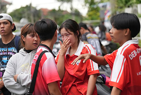 A schoolgirl cries outside her school where deaths and injuries were reported after a shooting in Thailand's Nonthaburi province, Friday, Aug. 7, 2026. 
