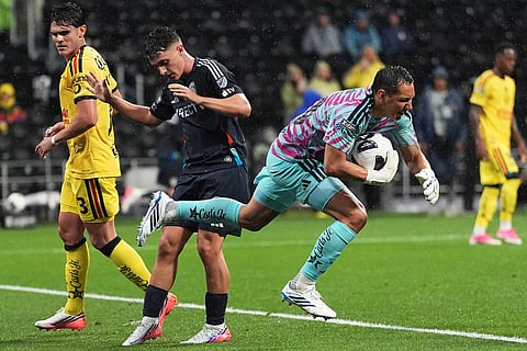 Rodolfo Cota goalkeeper of Mexico's America, right, catches the ball past Luca Bombino of The United States' San Diego FC during a Leagues Cup soccer match in Mexico City.