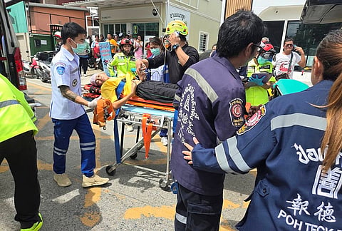 An injured is carried on a stretcher after a school shooting in Thailand's Nonthaburi province, Friday, Aug. 7, 2026. 