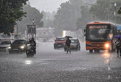 Vehicles wade during monsoon showers near Connaught Place, in New Delhi. The IMD issued a red alert for Delhi, forecasting moderate rain accompanied by moderate thunderstorms and lightning over the next few hours. 