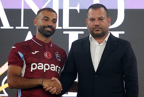 Egypt's Mohamed Salah, left, shakes hands with Trabzonspor president Ertugrul Dogan during his official presentation as a new Trabzonspor soccer player, in Trabzon, Turkey, Thursday, Aug. 6, 2026. 
