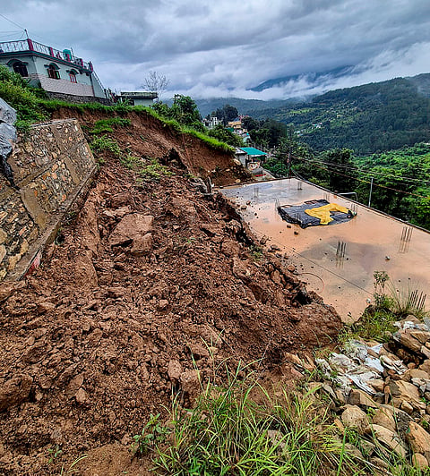 Debris scattered at the site after a landslide occured near a residential colony due to continuous heavy rainfall, putting several houses in risk, in Chamoli, Uttarakhand.
