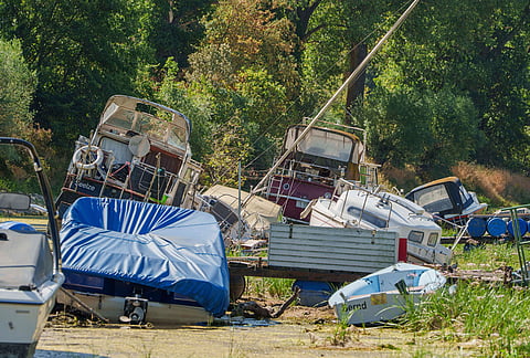 Recreational boats lie aground in the nearly dry Mühlarm, a side channel of the Rhine, amid low water levels in Nackenheim, Germany, Thursday, Aug. 6, 2026. 