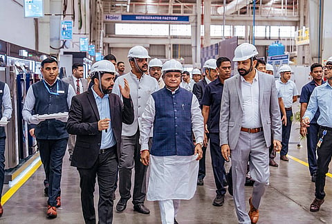 Odisha Chief Minister Mohan Charan Majhi interacts with company officials and technicians during a visit to Haier manufacturing facility, at Noida in Gautam Buddha Nagar district, Uttar Pradesh. 