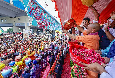 Uttar Pradesh Chief Minister Yogi Adityanath showers flower petals on 'Kanwariyas' in the sacred month of 'Shravan' during an event, in Meerut district. 