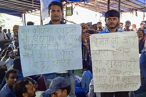 In this image received on Aug. 9, 2026, People hold posters during a protest over the alleged recruitment exam irregularities, in Ranchi.