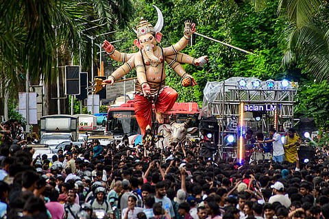People take an idol of Lord Ganesha to their pandal during a procession ahead of the 'Ganesh Chaturthi' festival, in Mumbai, Maharashtra.